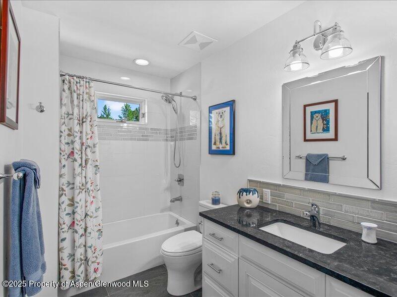 4100 County Road 103 Carbondale, CO 81623 - Photo 27 of 43 a bathroom with a granite countertop sink toilet and shower