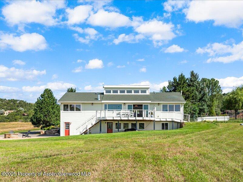 4100 County Road 103 Carbondale, CO 81623 - Photo 3 of 43 a view of a big yard with a house in the background