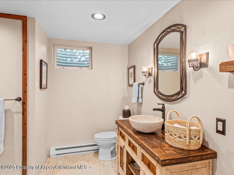 4100 County Road 103 Carbondale, CO 81623 - Photo 33 of 43 a bathroom with a granite countertop toilet sink and mirror