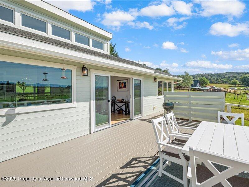 4100 County Road 103 Carbondale, CO 81623 - Photo 9 of 43 a view of a patio with chairs and floor to ceiling window next to a yard