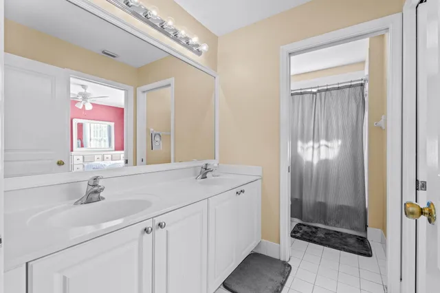 a bathroom with a sink a shower and a mirror