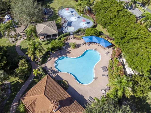 an aerial view of a house with a swimming pool patio and outdoor seating