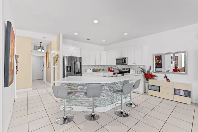 a large white kitchen with cabinets