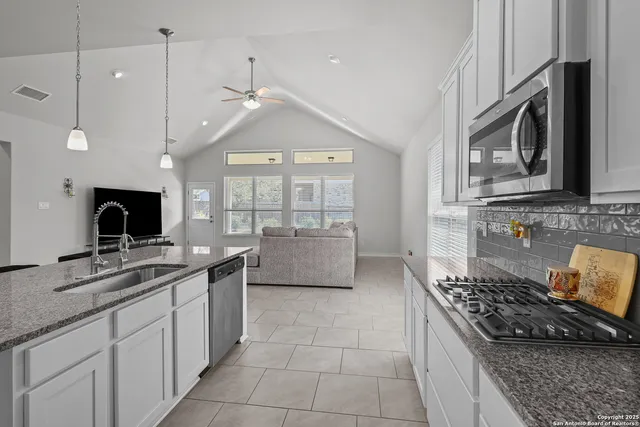 a kitchen with a stove and a sink