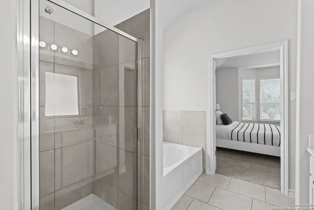 a bathroom with a tub and shower