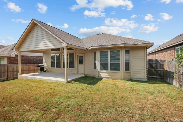a view of a house with a yard and sitting area