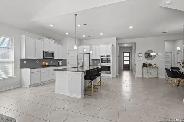 a kitchen with a white cabinets and counter space