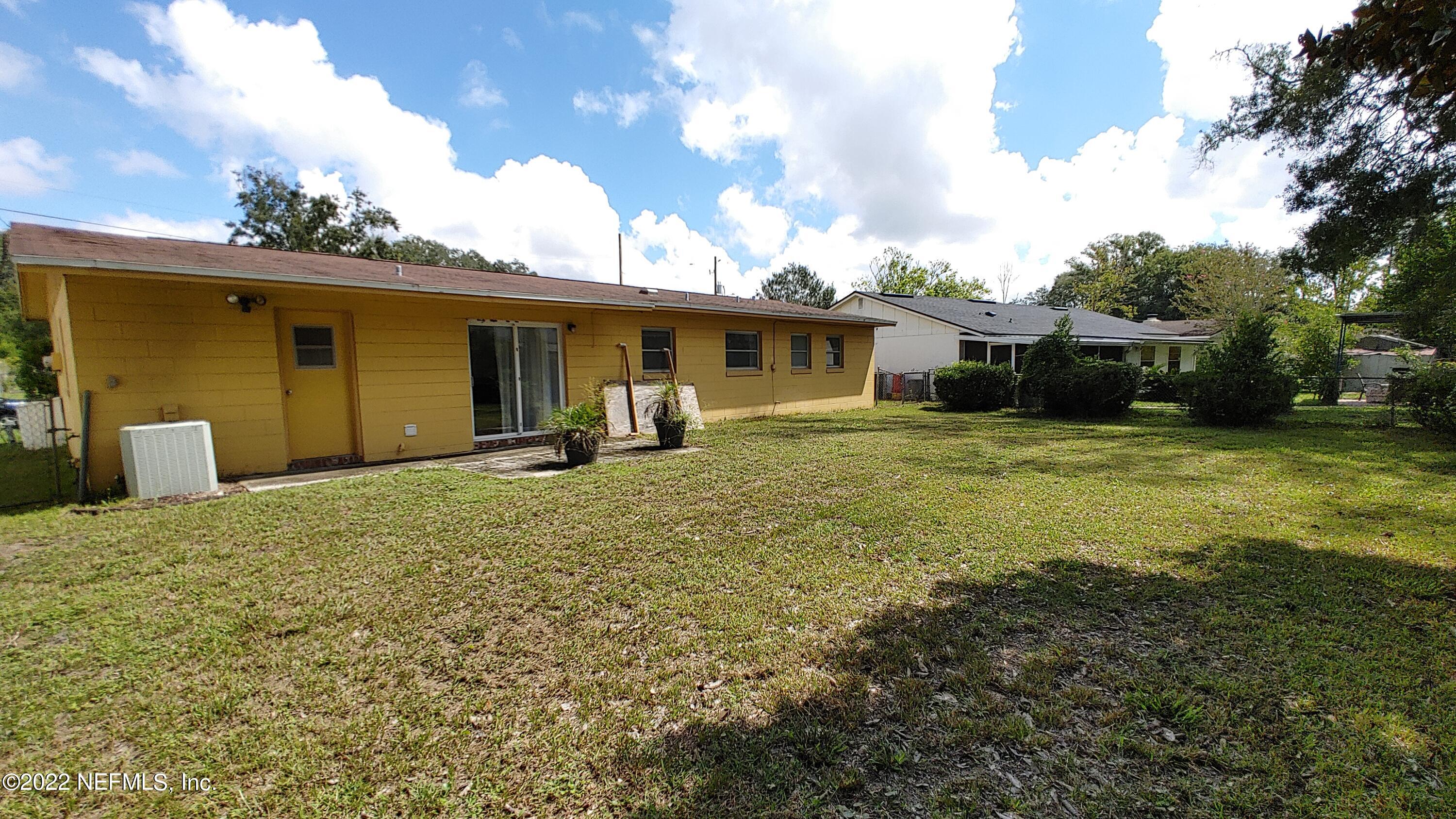 8280 Barracuda Road Jacksonville, FL 32244 - Photo 13 of 13 a view of a house with a yard and garage