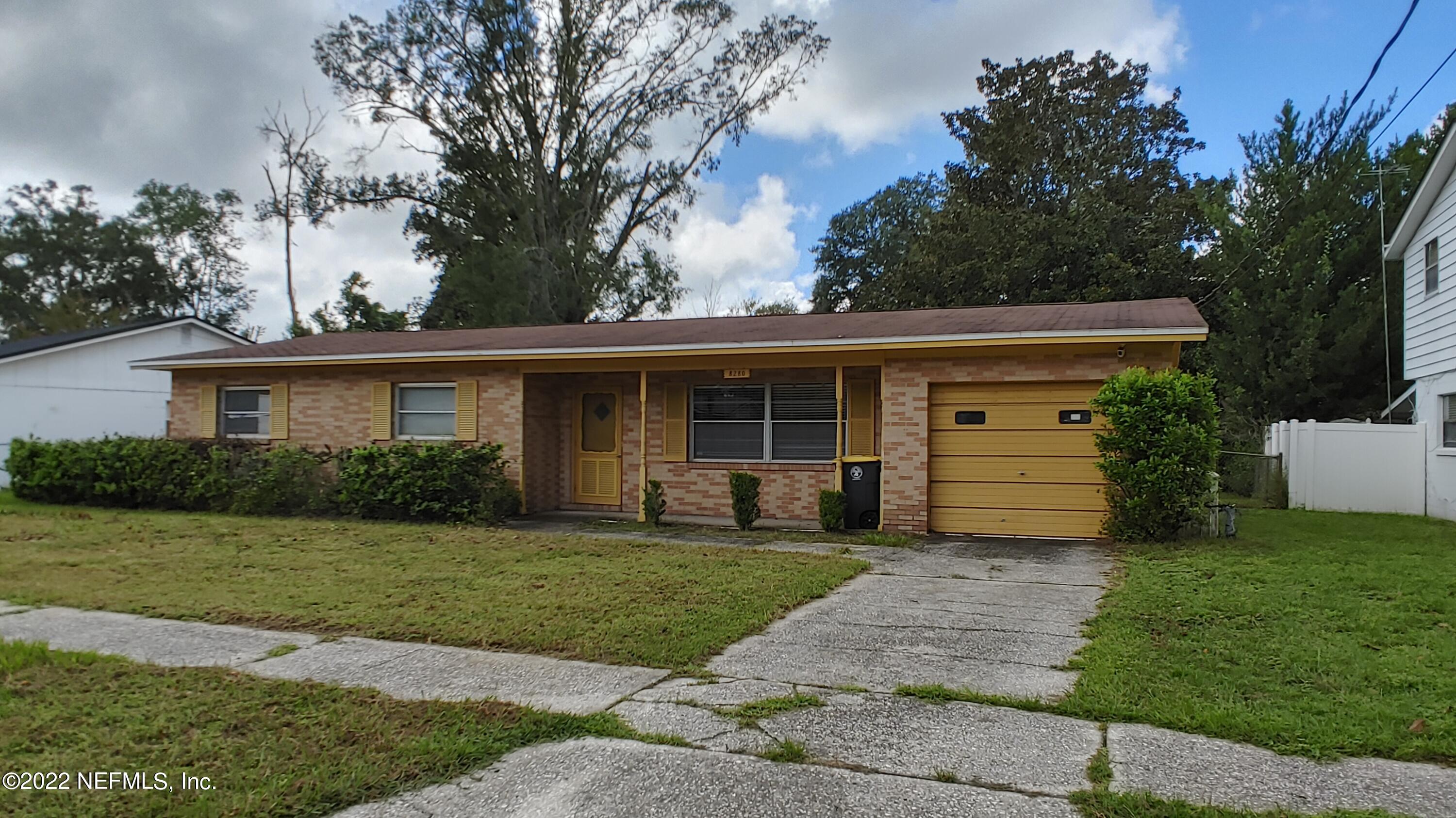 8280 Barracuda Road Jacksonville, FL 32244 - Photo 3 of 13 a front view of a house with a garden and yard
