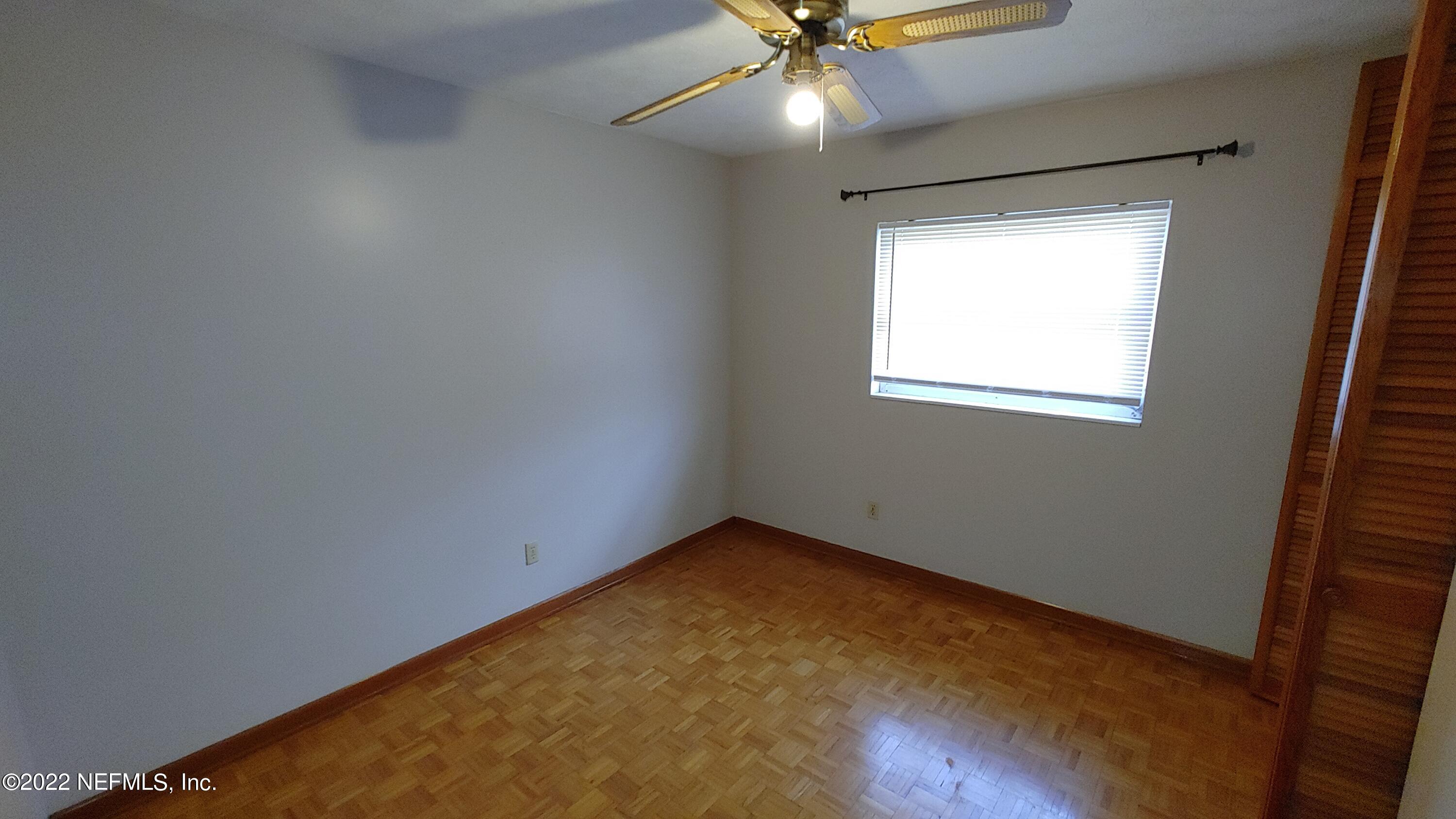8280 Barracuda Road Jacksonville, FL 32244 - Photo 8 of 13 an empty room with a window and a fan