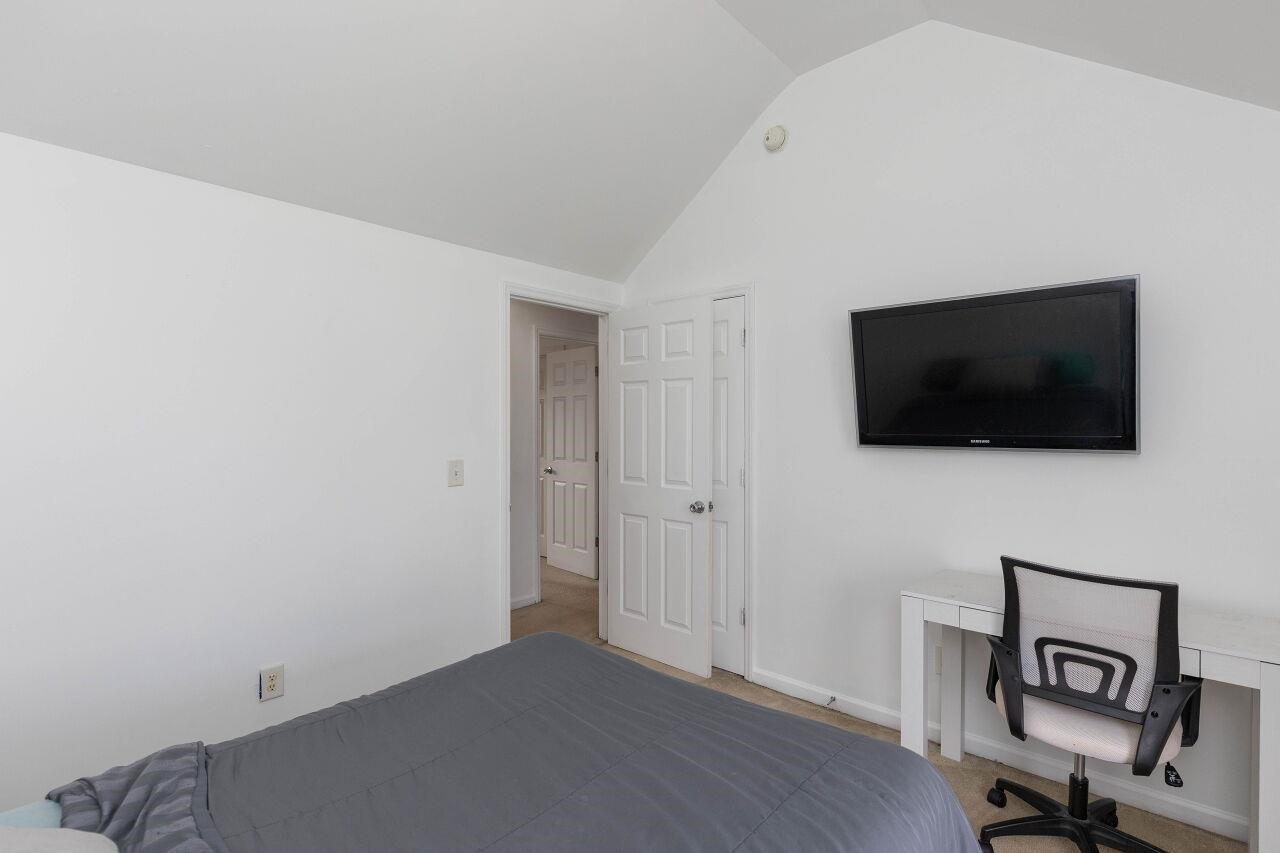 3409 Colossae Court Raleigh, NC 27610 - Photo 24 of 28 a view of a livingroom with a flat screen tv and wooden floor