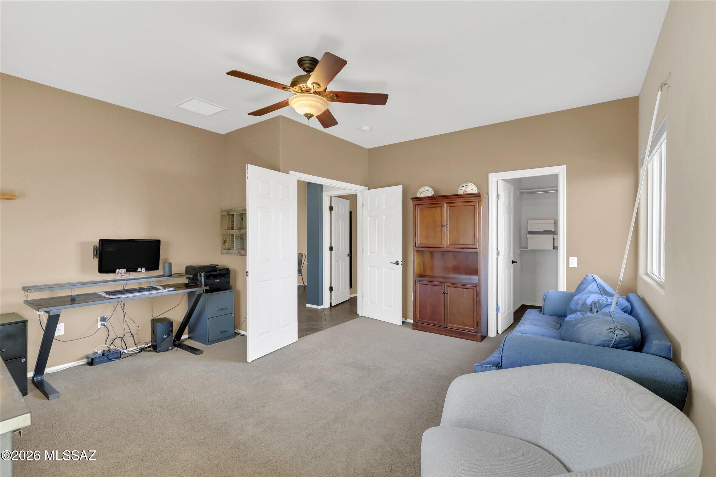 6095 South Jakemp Trail Tucson, AZ 85747 - Photo 13 of 52 a living room with furniture and a flat screen tv