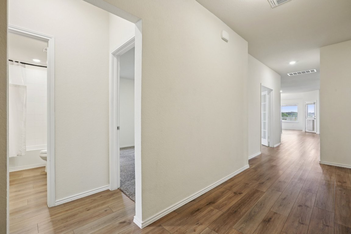 117 Break Avenue Taylor, TX 76574 - Photo 16 of 40 a view of a hallway with wooden floor