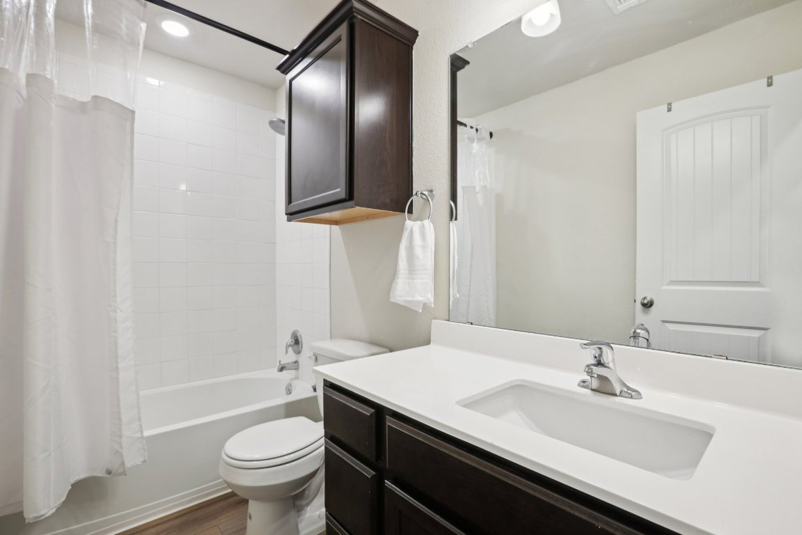 117 Break Avenue Taylor, TX 76574 - Photo 20 of 40 a bathroom with a sink and a mirror
