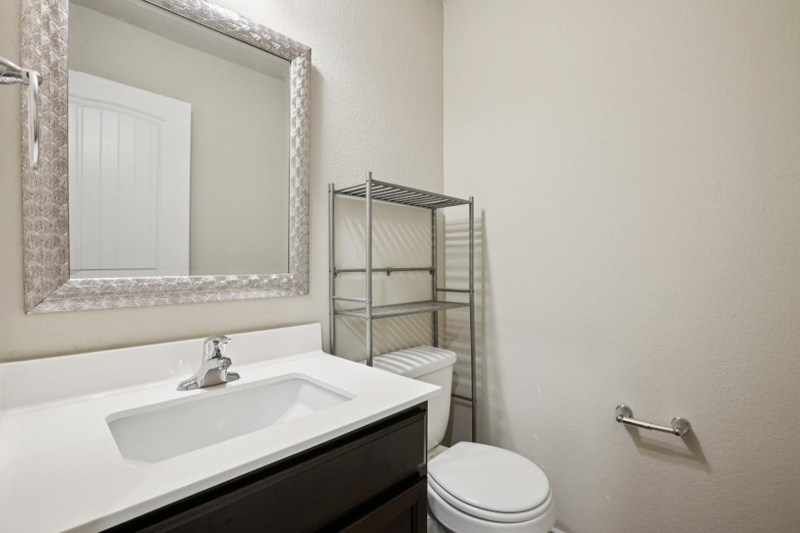 117 Break Avenue Taylor, TX 76574 - Photo 25 of 40 a bathroom with a sink toilet and mirror