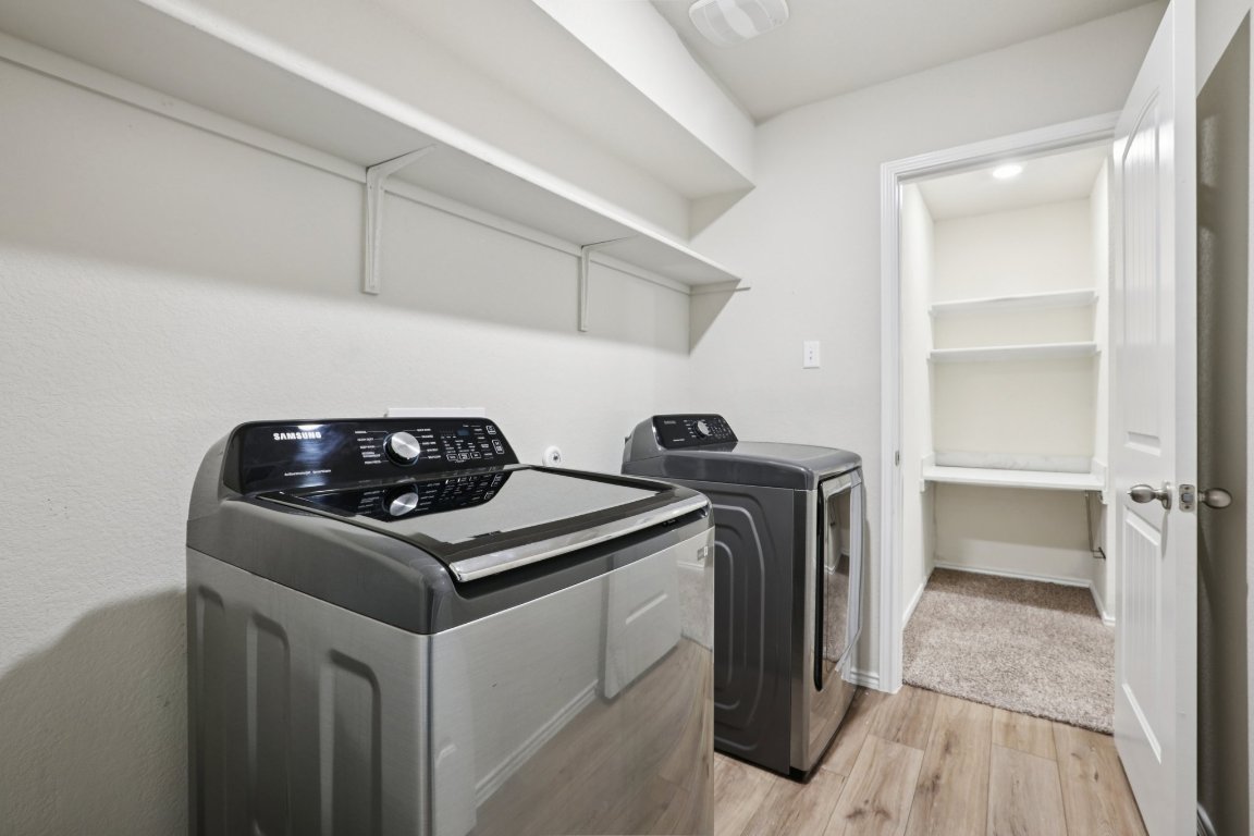 117 Break Avenue Taylor, TX 76574 - Photo 26 of 40 a kitchen with a stove and a refrigerator