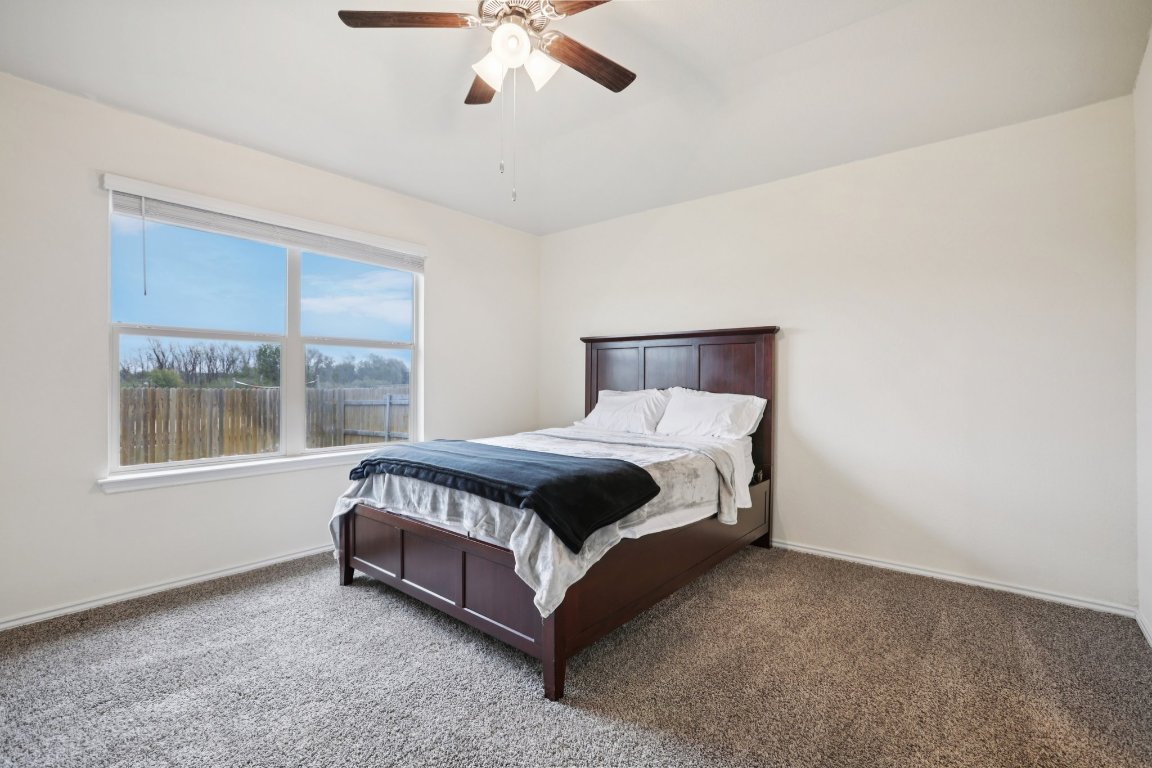 117 Break Avenue Taylor, TX 76574 - Photo 32 of 40 a large bed sitting in a room next to a window