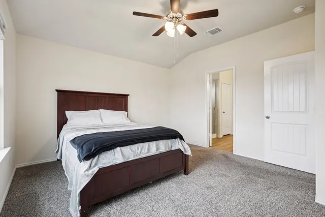 a bedroom with a bed and window