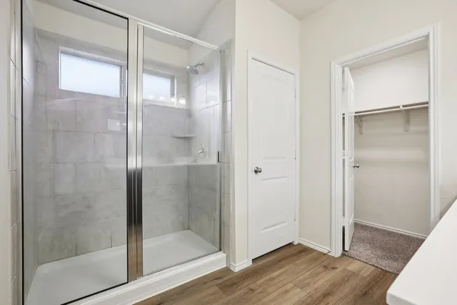 a bathroom with a glass shower door