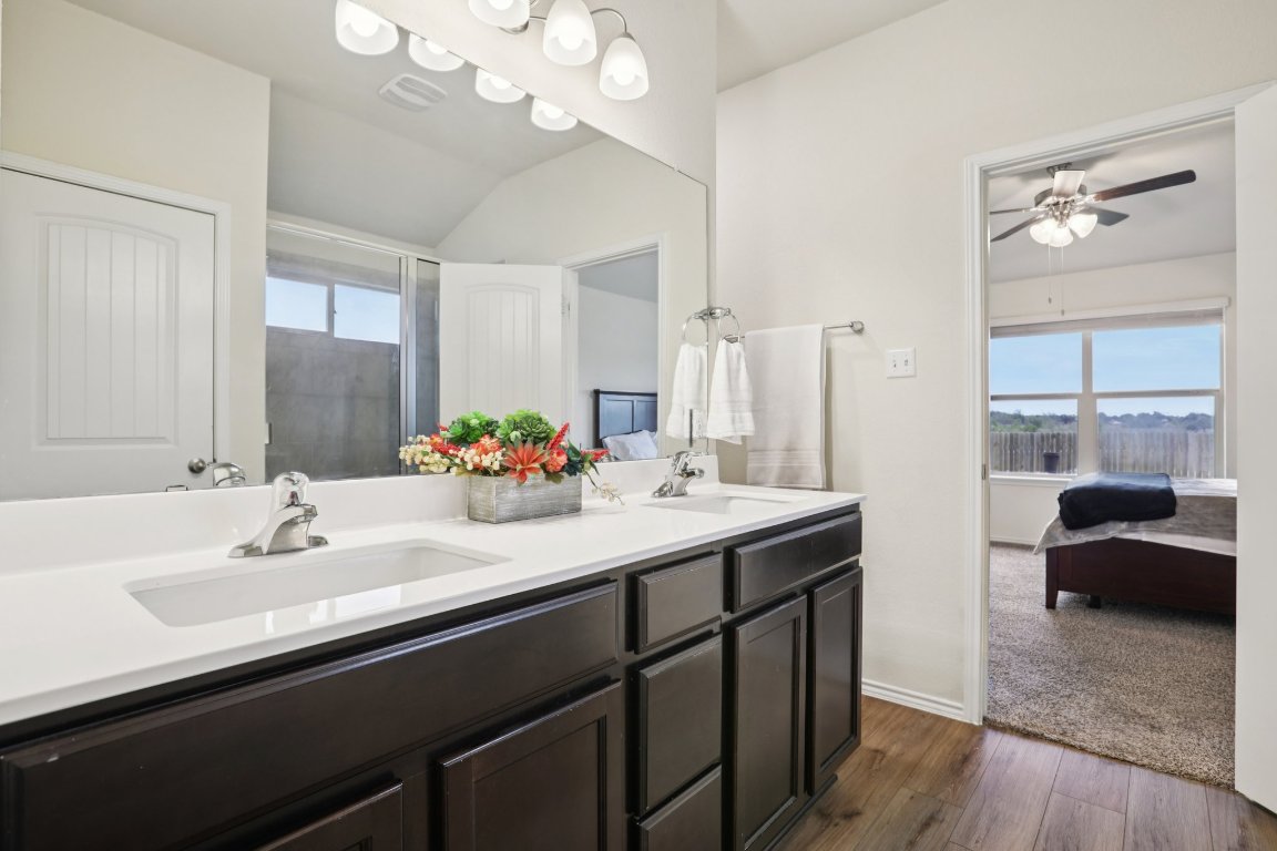 117 Break Avenue Taylor, TX 76574 - Photo 39 of 40 a en suite bathroom with a double vanity sink a mirror and a shower