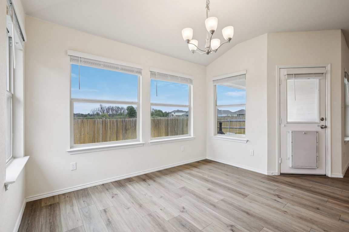117 Break Avenue Taylor, TX 76574 - Photo 10 of 40 a view of an empty room with wooden floor and a window