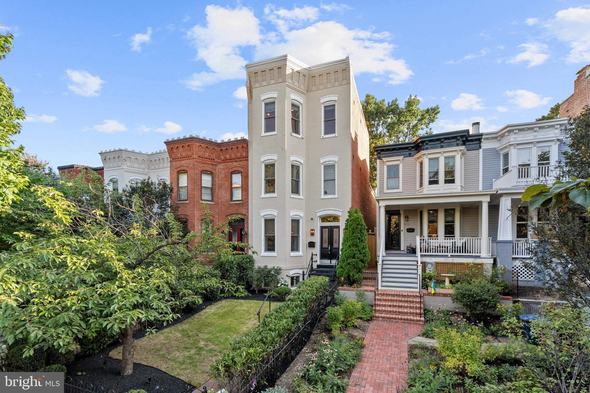 a front view of a residential apartment building with a yard