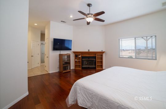 411 North Nolan Street Ridgecrest, CA 93555 - Photo 22 of 43 a bedroom with a bed and a flat screen tv