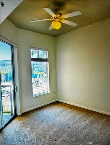 a view of a livingroom with furniture and a large window
