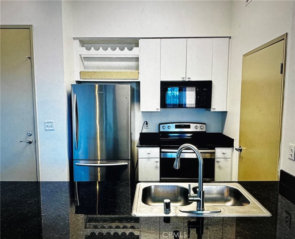 488 East Ocean Boulevard, Unit 418 Long Beach, CA 90802 - Photo 2 of 29 a kitchen with a sink a refrigerator and a stove