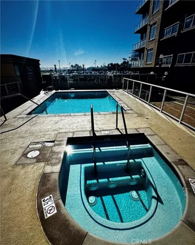 a swimming pool with outdoor seating and yard