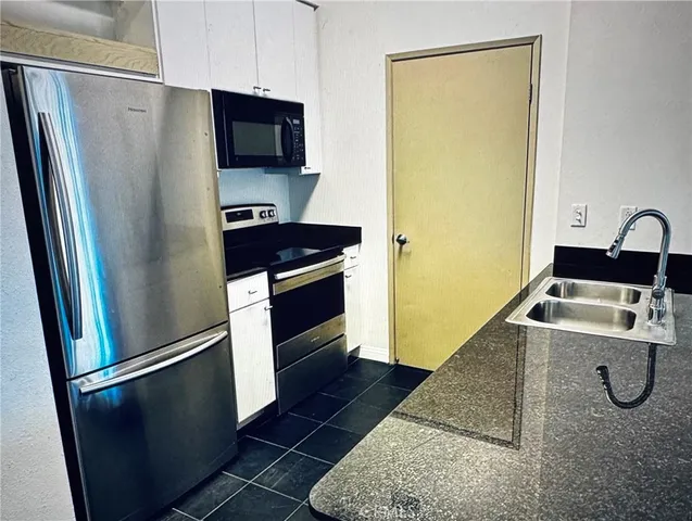 a kitchen with a refrigerator sink and stove