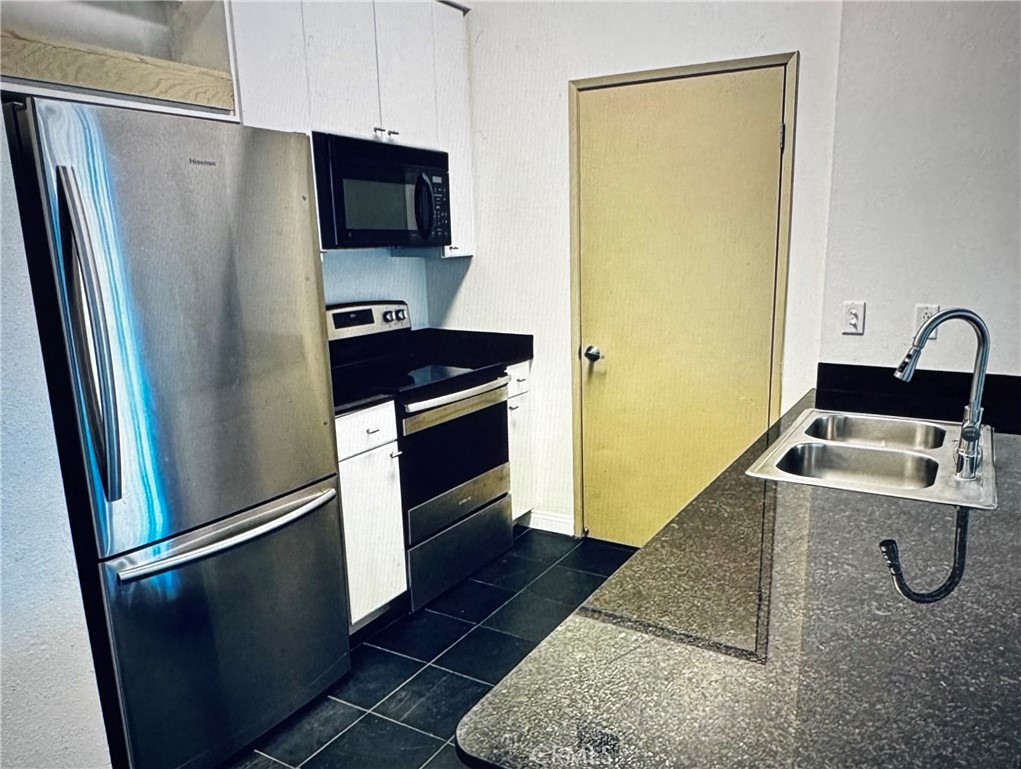 488 East Ocean Boulevard, Unit 418 Long Beach, CA 90802 - Photo 3 of 29 a kitchen with a refrigerator sink and stove