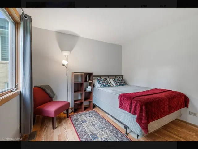 a bedroom with a bed and glass chair