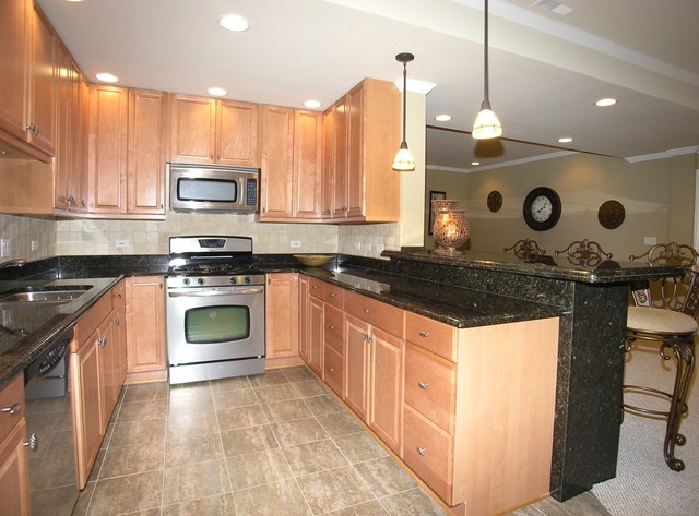 611 Greendale Road Glenview, IL 60025 - Photo 18 of 25 a kitchen with stainless steel appliances granite countertop a stove a sink and a microwave