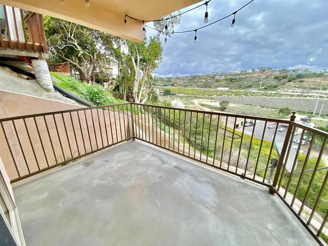 a bathroom with a granite countertop sink a toilet a mirror and vanity