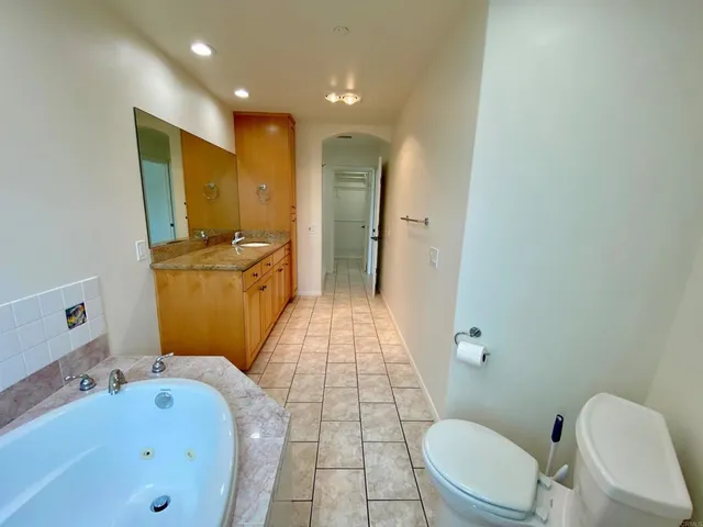 a view of a house with a cars park side of a road