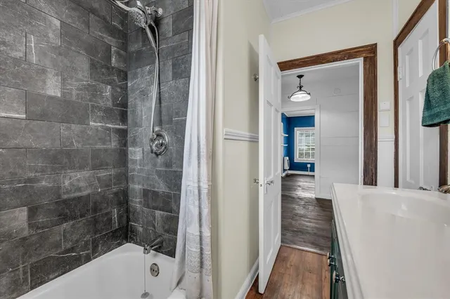 a bathroom with a bathtub and a shower