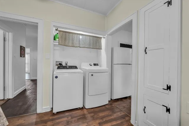 a white refrigerator freezer and a wooden floor
