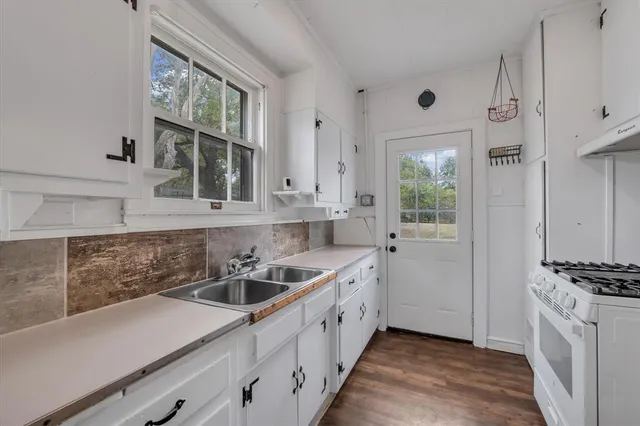 a kitchen with cabinets a sink and appliances