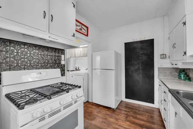 a kitchen with stainless steel appliances granite countertop a refrigerator and a stove