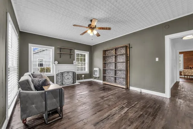 a living room with furniture and a ceiling fan