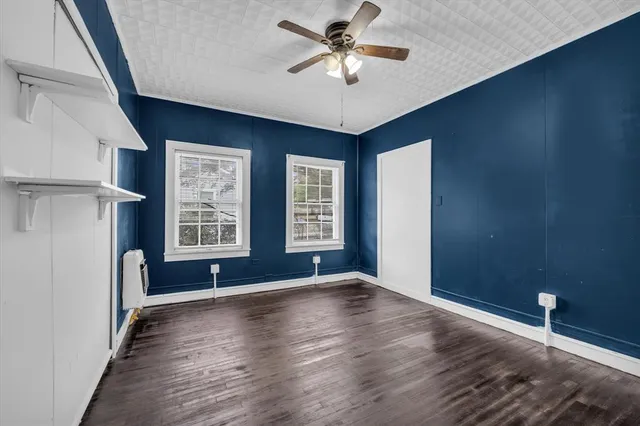 wooden floor in an empty room with a window
