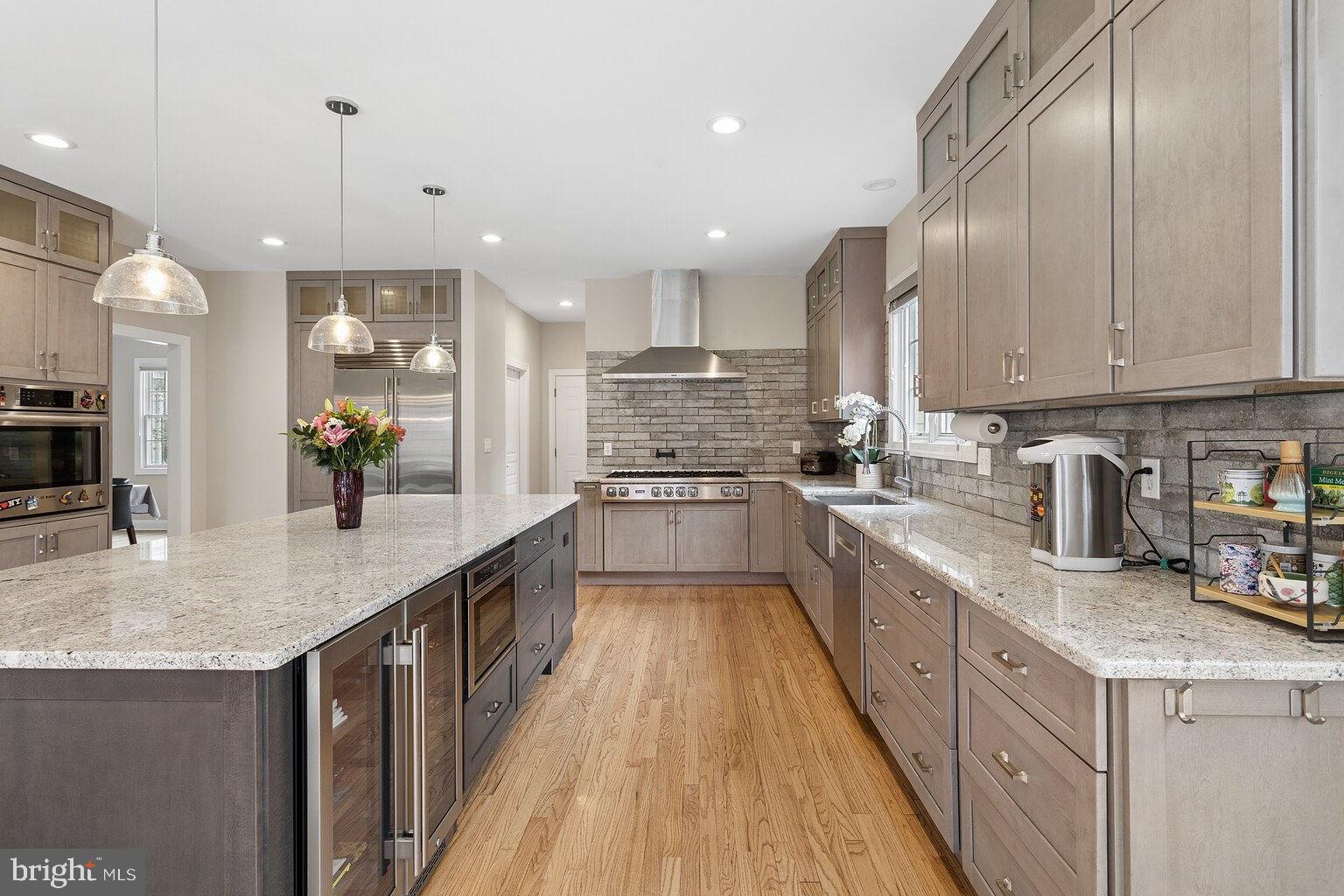 29 Dempsey Avenue Princeton, NJ 08540 - Photo 18 of 58 a large kitchen with stainless steel appliances granite countertop a lot of counter space and wooden floor