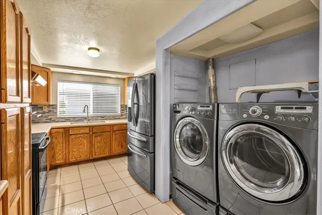 a kitchen with a sink a counter top space cabinets and a window