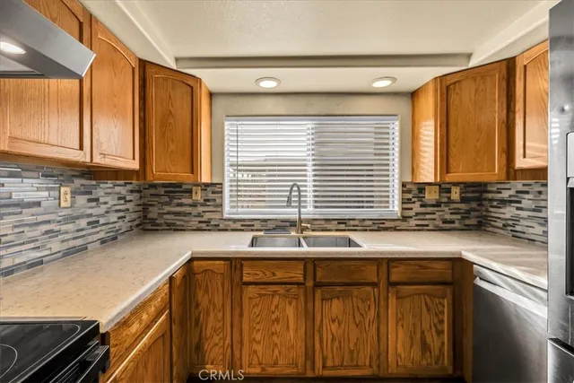a kitchen with stainless steel appliances granite countertop a refrigerator and a stove