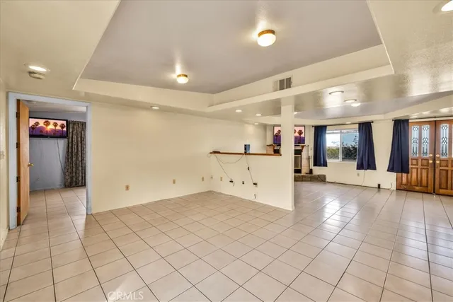 a view of a hallway with cabinet and a large window