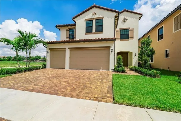 a front view of a house with a yard and garage