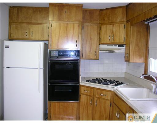 967 New Dover Road Edison, NJ 08820 - Photo 3 of 8 a kitchen with a refrigerator and a sink