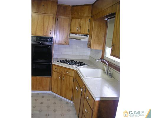 967 New Dover Road Edison, NJ 08820 - Photo 4 of 8 a kitchen with a sink stove and refrigerator