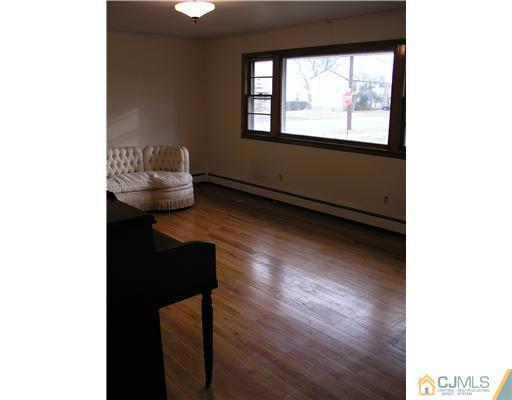 967 New Dover Road Edison, NJ 08820 - Photo 5 of 8 a living room with wooden floor and a potted plant